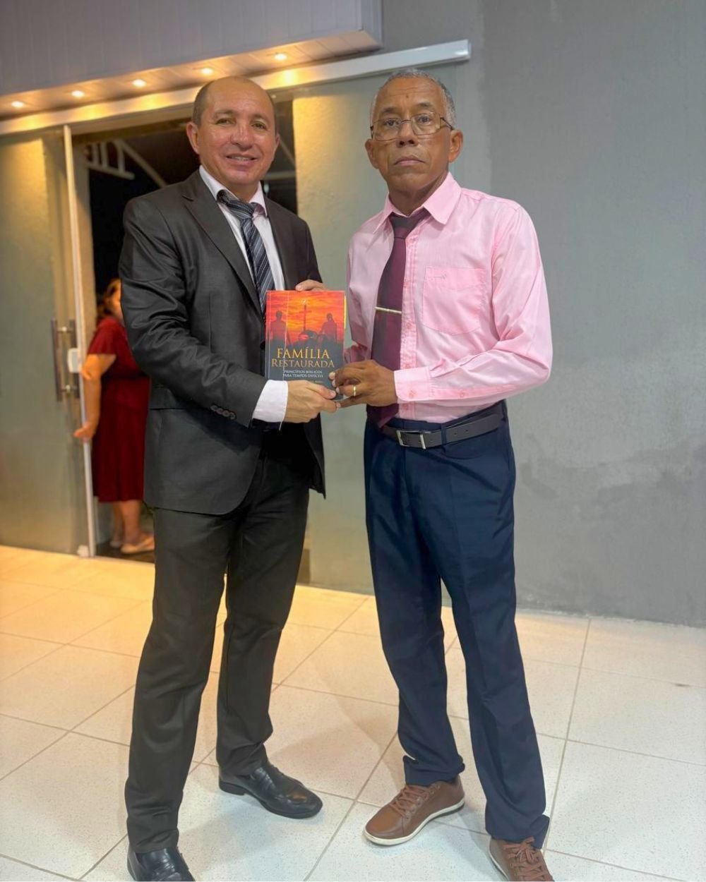 Izequiel Ferreira entregando um exemplar do livro Família Restaurada